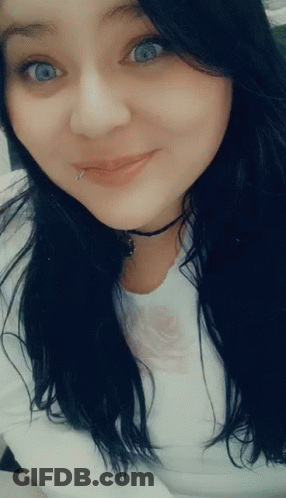 A Woman With A Piercing In Her Lip Is Smiling GIF