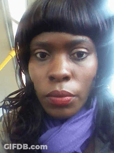 A Woman With A Purple Scarf Around Her Neck GIF