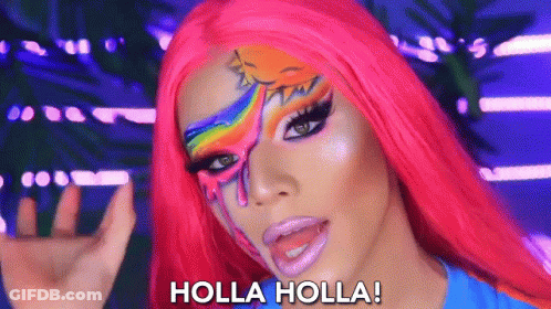 A Woman With A Rainbow Painted On Her Face Says Holla Holla GIF