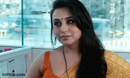 A Woman With A Red Dot On Her Forehead Is Sitting In A Cubicle GIF