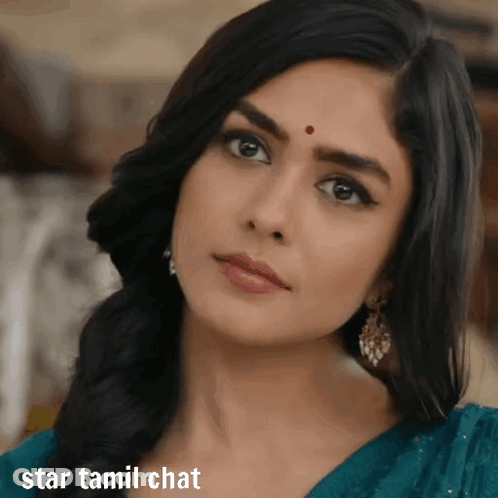 A Woman With A Red Dot On Her Forehead Looks At The Camera With The Words Star Tamil Chat Below Her GIF