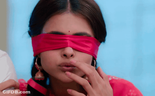 A Woman With A Red Ribbon Around Her Eyes GIF