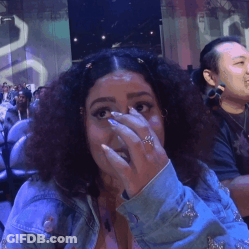 A Woman With A Ring On Her Finger Covering Her Face GIF