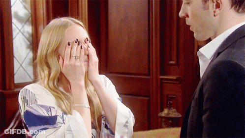 A Woman With A Ring On Her Finger Covers Her Face With Her Hands GIF