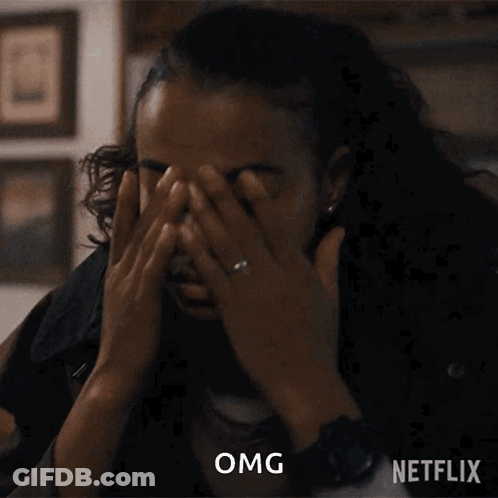 A Woman With A Ring On Her Finger Is Covering Her Face With Her Hands And A Netflix Logo Is Behind Her GIF
