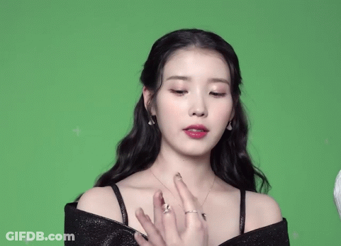 A Woman With A Ring On Her Finger Is Covering Her Mouth With Her Hands GIF