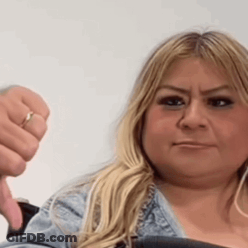 A Woman With A Ring On Her Finger Is Giving A Thumbs Down GIF