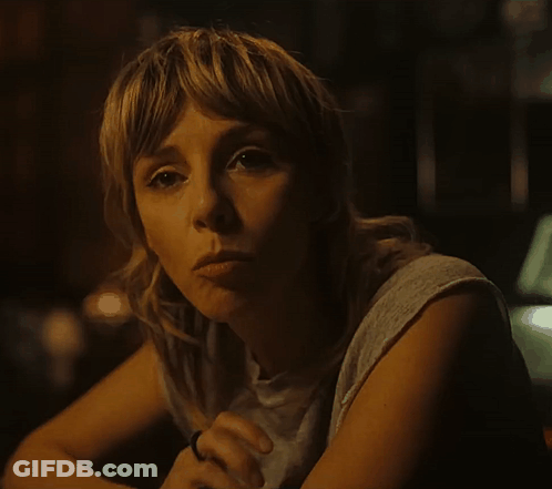 A Woman With A Ring On Her Finger Is Looking At The Camera GIF