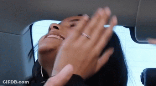 A Woman With A Ring On Her Finger Is Smiling And Clapping GIF