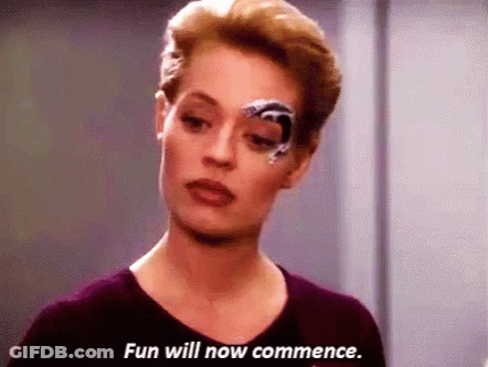 A Woman With A Robotic Eye Is Saying `` Fun Will Now Commence . '' GIF