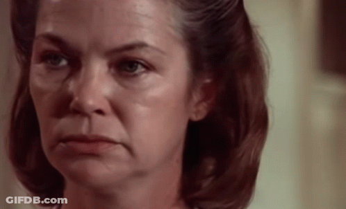 A Woman With A Sad Look On Her Face GIF