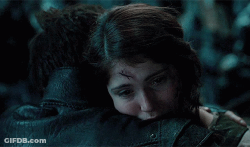 A Woman With A Scar On Her Forehead Is Hugging A Man In A Leather Jacket GIF