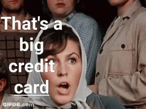 A Woman With A Scarf Around Her Head And The Words That 'S A Big Credit Card Above Her GIF