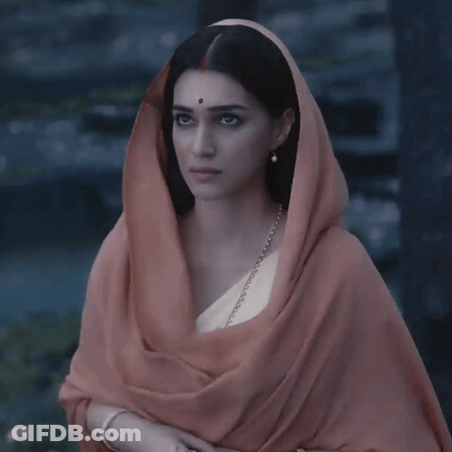 A Woman With A Scarf Around Her Head Has A Red Dot On Her Cheek GIF