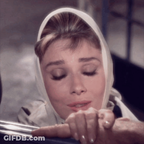 Woman With Scarf Looking Down GIF