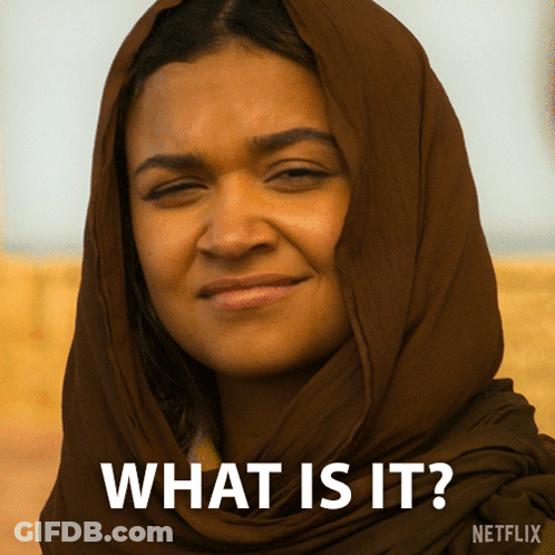 A Woman With A Scarf Around Her Head Says What Is It On The Bottom GIF