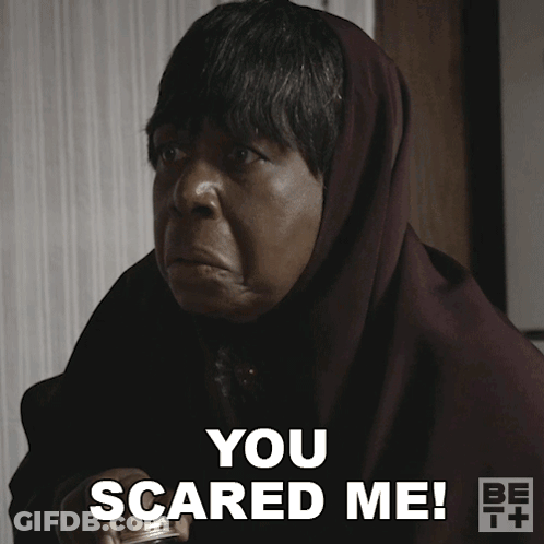 A Woman With A Scarf Around Her Head Says " You Scared Me " GIF