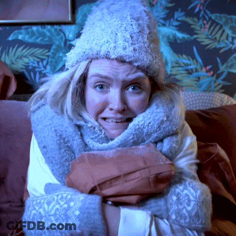 A Woman With A Scarf Around Her Neck And A Hat On GIF