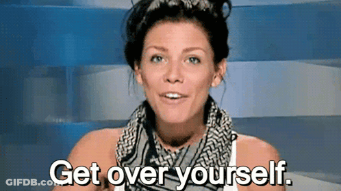 A Woman With A Scarf Around Her Neck Is Saying Get Over Yourself . GIF