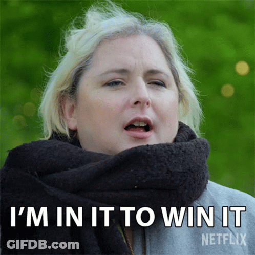 A Woman With A Scarf Around Her Neck Is Saying I 'M In It To Win It GIF