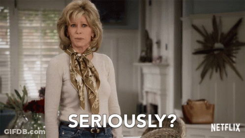A Woman With A Scarf Around Her Neck Is Saying Seriously GIF