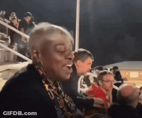 A Woman With A Scarf Around Her Neck That Says ' U.s.a. ' GIF