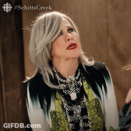 A Woman With A #Schitts Creek Logo On The Bottom Right GIF