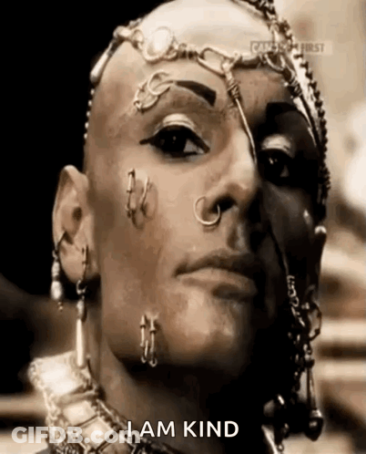 A Woman With A Shaved Head And Piercings On Her Face Says I Am Kind GIF