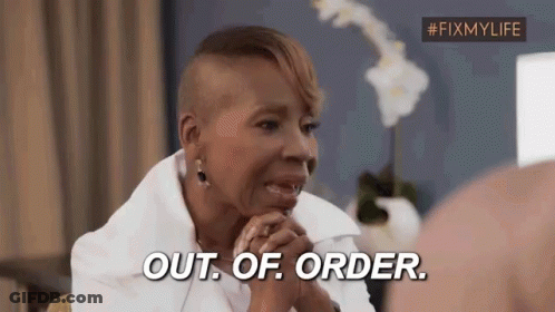 A Woman With A Shaved Head Is Sitting In A Chair And Says `` Out Of Order '' . GIF