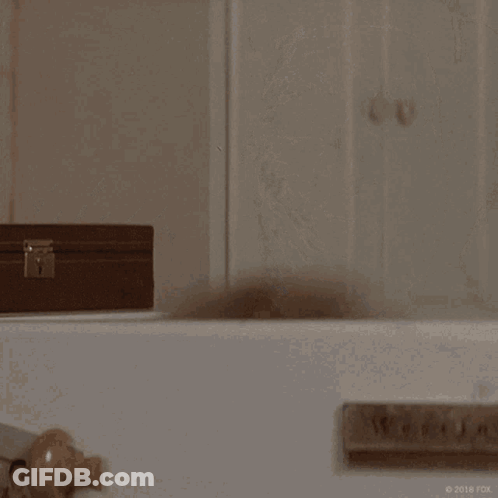 A Woman With A Shaving Cream Mask On Her Face Is Saying Hello GIF