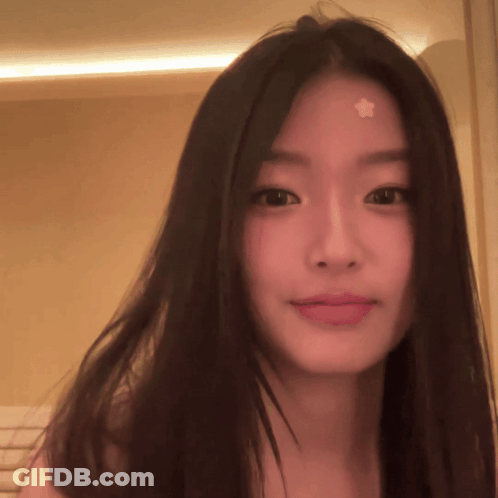 A Woman With A Star On Her Forehead Looks At The Camera GIF
