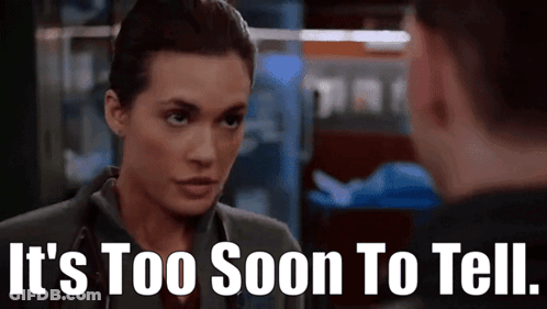 A Woman With A Stethoscope On Her Neck Is Talking To A Man . GIF
