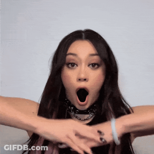 A Woman With A Surprised Look On Her Face And Her Mouth Open GIF