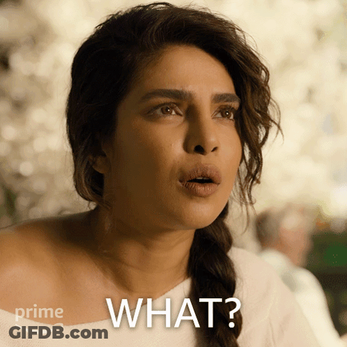 A Woman With A Surprised Look On Her Face And The Words " What " On The Bottom GIF