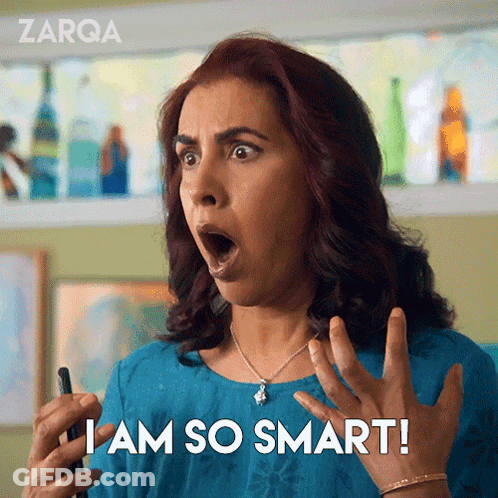 A Woman With A Surprised Look On Her Face Is Holding A Cell Phone And Says I Am So Smart GIF