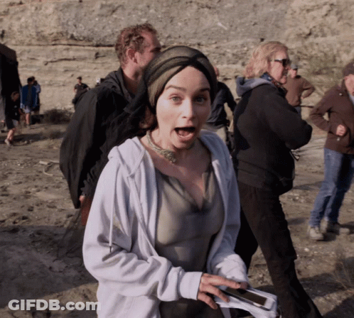 A Woman With A Surprised Look On Her Face Is Holding A Cellphone GIF