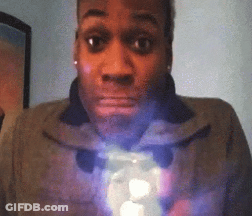 A Woman With A Surprised Look On Her Face Is Holding A Light GIF