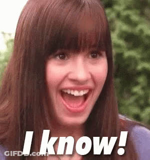 A Woman With A Surprised Look On Her Face Is Smiling And Says I Know . GIF