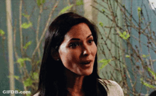 Surprised Woman Standing In Front Of Tree GIF