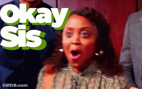 A Woman With A Surprised Look On Her Face Is Standing In Front Of Okay Sis GIF
