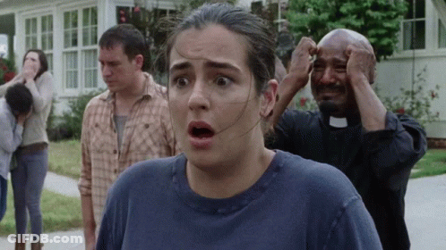 A Woman With A Surprised Look On Her Face Is Standing Next To A Priest GIF