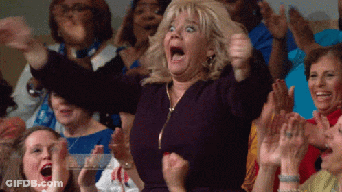 A Woman With A Surprised Look On Her Face Is Surrounded By Other People GIF