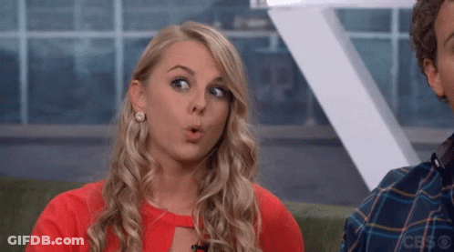 A Woman With A Surprised Look On Her Face Is Wearing A Red Top GIF