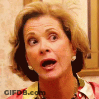 A Woman With A Surprised Look On Her Face Is Wearing Earrings . GIF
