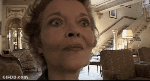 A Woman With A Surprised Look On Her Face Looks At The Camera GIF