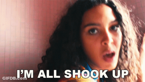 A Woman With A Surprised Look On Her Face Says I 'M All Shook Up . GIF