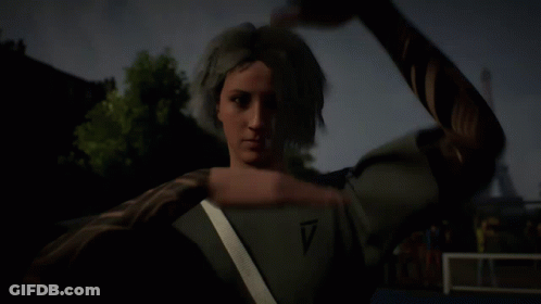 A Woman With A Tattoo On Her Arm Is Making A Hand Gesture GIF