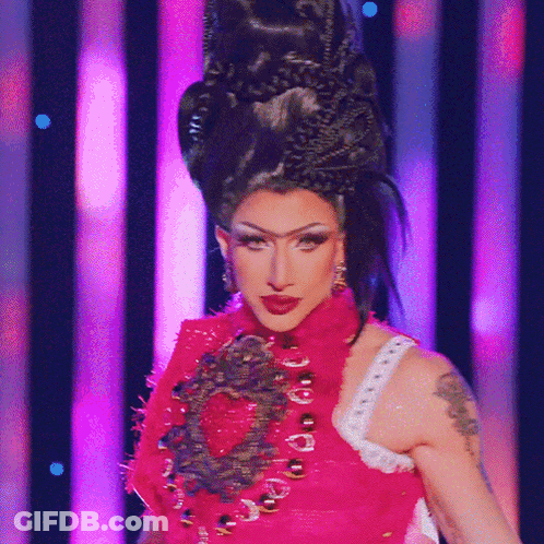 A Woman With A Tattoo On Her Arm Is Wearing A Red Dress GIF