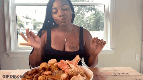 A Woman With A Tattoo On Her Chest Is Eating A Bowl Of Food GIF