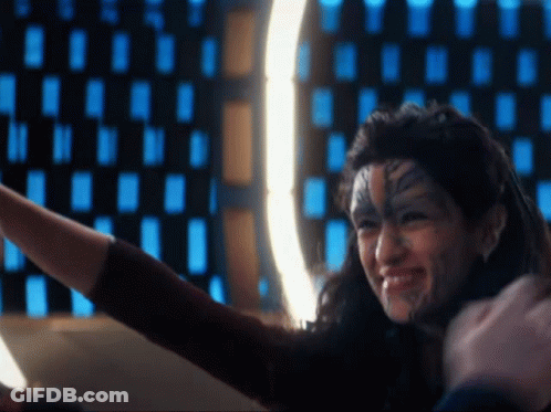 A Woman With A Tattoo On Her Face Is Smiling While Taking A Selfie GIF